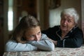 A little girl is comforted by her grandmother