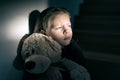 Sad little girl holding her teddy bear - she feels lonely Royalty Free Stock Photo