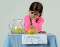 Sad little girl at lemonade stand in summer Royalty Free Stock Photo