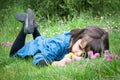 Sad little girl lying in the grass Royalty Free Stock Photo