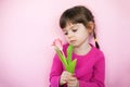 Sad little girl with pink tulip Royalty Free Stock Photo