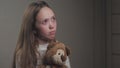 Sad little girl praying while holding a teddy bear in her hands. The teenager seeks protection from God. A lonely child Royalty Free Stock Photo