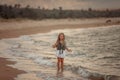 Sad little girl on the shore of the sea Royalty Free Stock Photo