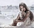 Sad little girl sits alone front of the window Royalty Free Stock Photo