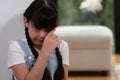 Sad little girl sitting alone in living room crying alone. Synchronos Royalty Free Stock Photo