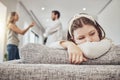 Sad little girl, sofa and parents in conflict, disagreement or fight in the living room at home. Family, divorce and Royalty Free Stock Photo