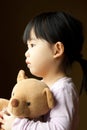 Sad little girl with teddy bear Royalty Free Stock Photo