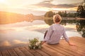 Sad lonely beautiful woman sitting on the pier Royalty Free Stock Photo