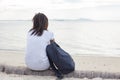 Sad lonely beautiful woman sitting on the pier Royalty Free Stock Photo