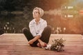 Sad lonely beautiful woman sitting on the pier Royalty Free Stock Photo