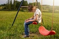 Sad lonely boy sitting on swing Royalty Free Stock Photo