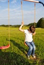 Sad lonely boy sitting on swing Royalty Free Stock Photo