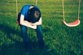 Sad lonely boy sitting on swing Royalty Free Stock Photo