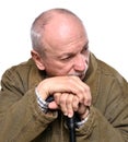 Sad lonely elderly man with a cane posing in studio Royalty Free Stock Photo