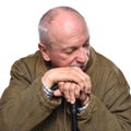 Sad lonely elderly man with a cane posing in studio Royalty Free Stock Photo