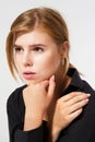 Sad lonely girl closeup. Portrait of a young sad female caucasian teen, on white. Young beautiful woman in depression, isolated on Royalty Free Stock Photo