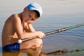 Sad and lonely kid boy sitting in the water Royalty Free Stock Photo