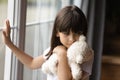 Sad lonely kid holding, hugging teddy bear toy Royalty Free Stock Photo