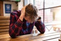 Sad lonely man sits at the bar at the table. Depression, crisis, alcohol addiction, lifestyle. Alcoholism concept Royalty Free Stock Photo