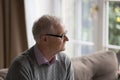 Sad lonely old man in eyeglasses looking at window away Royalty Free Stock Photo