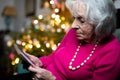 Sad And Lonely Senior Woman Spending Christmas At Home Alone Looking At Family Photograph Royalty Free Stock Photo