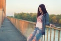 Sad lonely teenage girl standing on the bridge on beautiful spring day Royalty Free Stock Photo