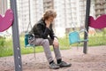 Sad lonely teenager outdoor on the Playground. the difficulties of adolescence in communication concept.