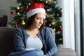 Sad lonely woman complaining in christmas at home