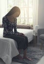 Sad lonely woman sitting on the bed