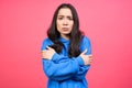 Sad lonely young Korean woman on a pink background Royalty Free Stock Photo