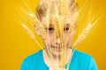 Sad look of the boy through the ears of wheat which he put to his face Royalty Free Stock Photo