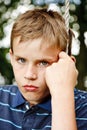 Sad looking boy sitting on a swing Royalty Free Stock Photo