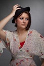 Sad looking brunette young woman with a hat Royalty Free Stock Photo