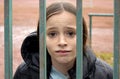 Girl locked in behind a fence