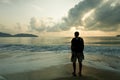 Sad man in the dawn time on the beach Royalty Free Stock Photo