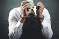 Sad man hand handcuffs with money Royalty Free Stock Photo
