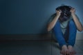 sad man hug his knee and cry sitting alone in a dark room. Depression, unhappy, stressed and anxiety disorder concept Royalty Free Stock Photo