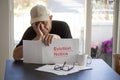 Sad man looking at Eviction Notice holding his head in his hands. Royalty Free Stock Photo