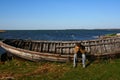 Sad man near the old wooden boat Royalty Free Stock Photo