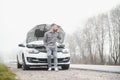 Sad man on the road next to the broken car Royalty Free Stock Photo