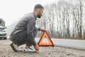 Sad man on the road next to the broken car Royalty Free Stock Photo