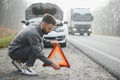 Sad man on the road next to the broken car Royalty Free Stock Photo