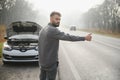 Sad man on the road next to the broken car Royalty Free Stock Photo