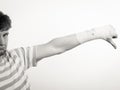 Sad man showing thumb down by bandaged hand. Royalty Free Stock Photo