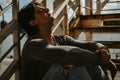 Sad man sitting on the staircase with eyes closed Royalty Free Stock Photo