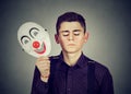 Sad man taking off happy clown mask. Split personality Royalty Free Stock Photo