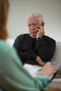 Sad man talking with psychiatrist