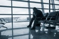 Sad man waiting for delayed flight Royalty Free Stock Photo