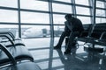 Sad man waiting for delayed flight Royalty Free Stock Photo