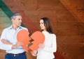 Sad mature couple holding broken heart Royalty Free Stock Photo